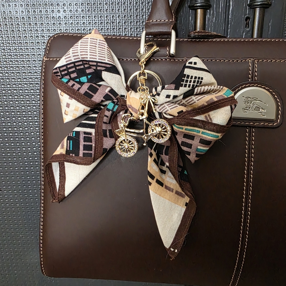 Elegant Brown Bow Bag Charm With Bicycle Accent
